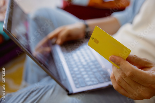 Closeup shot of male hand holding plastic credit card for travel payment online