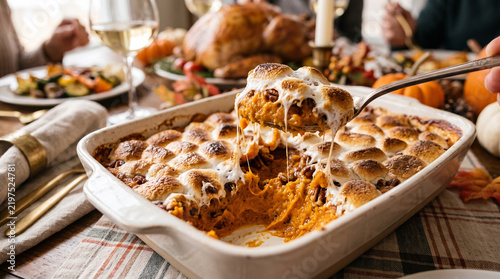 Sweet potato casserole with marshmallows on a festive holiday table  
