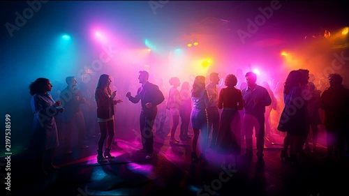 Crowd of people dancing and enjoying a party in a nightclub with colorful lights and smoke