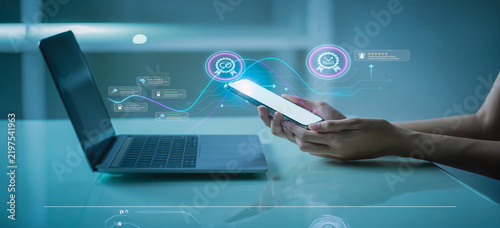 Person using smartphone connected to digital interface with laptop