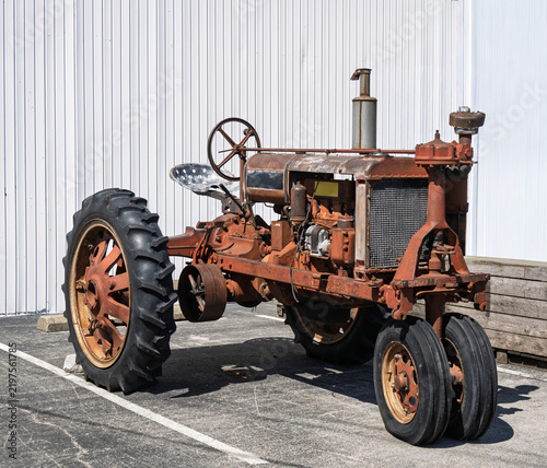 Rusty 1939 vintage tractor parked on concrete