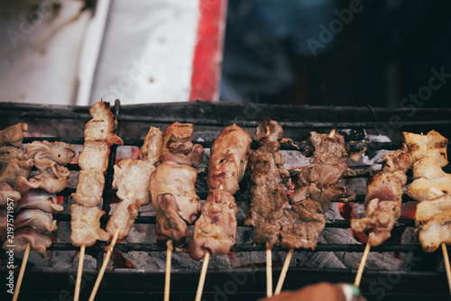 Принти на полотні Assorted meat and chicken entrails grilling on charcoal grill.