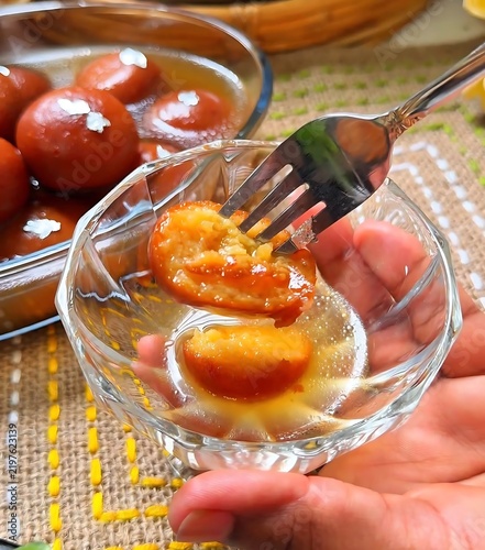 Bild auf Leinwand Gulab Jamun Indian Dessert Served in Sugar Syrup with Fork