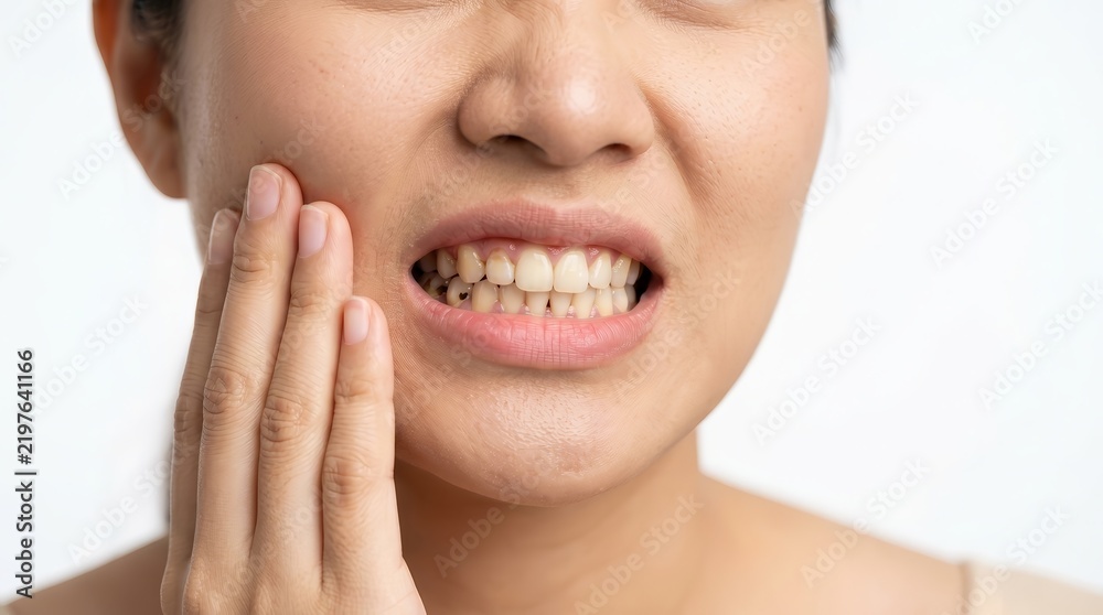 Obraz premium Close up of an Asian female suffering from tooth decay and dental care problems.