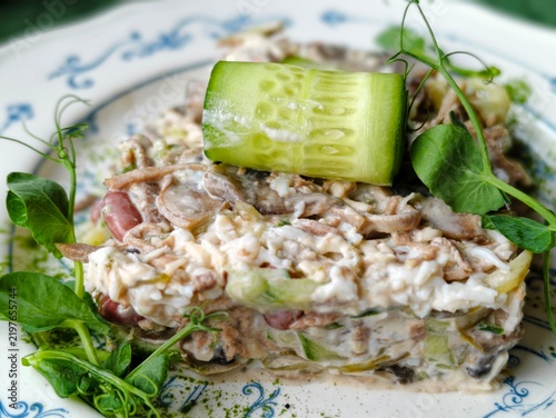 Canvastavla Fresh salad on a white plate topped with cucumbers