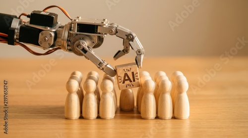 Robotic hand placing wooden block with ai symbol into group of peg people on table