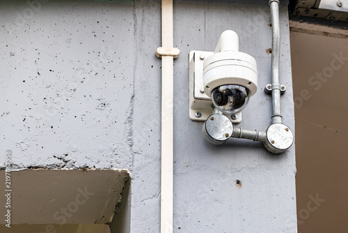 Fotografie Dome CCTV security camera mounted on exterior building wall
