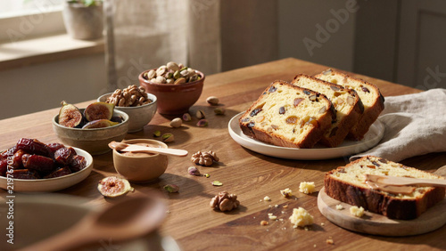 Fruit and Nut Loaf Slices with Dates, Figs, Pistachios and Walnuts on Rustic Wooden Table