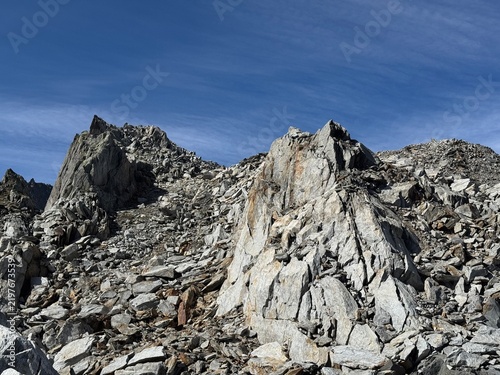 Rugged rock formations and giant granite boulders along a high-altitude hiking route in the Swiss Alps near Realp in the canton of Uri, showing steep cliffs, alpine terrain and dramatic mountain