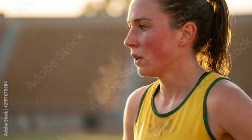 Female athlete exhaling steam in stadium during championship match woman's soccer football concept