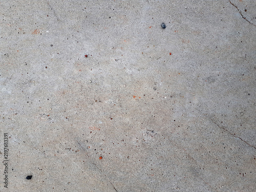 Grunge Grey Concrete Surface Background. A rough, weathered surface. A dirty, mottled texture covered with cracks and small stones. Horizontal photo.