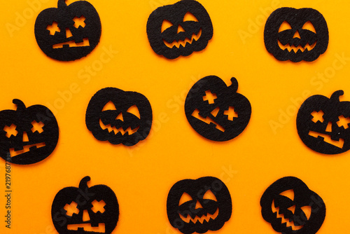 Small decorative halloween pumpkins on color background, top view