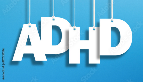 ADHD letters hanging over blue background