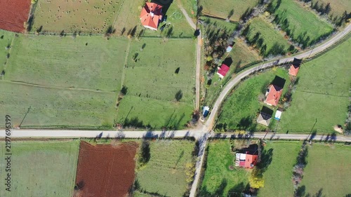 Aerial view of scattered farmhouses and converging village roads through open farmland in Mengen, Bolu, Turkey