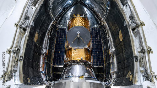 Communications Satellite Folded Inside Rocket Payload Fairing Capsule, Spacecraft Nose Cone Interior Assembly Before Low Earth Orbit Launch
