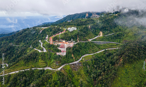 Aerial view of residential houses nestled in lush green hills