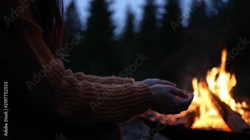 Person Warming Hands By Campfire Night. 4K Video