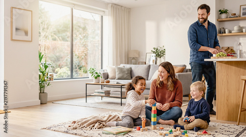 Happy family spending quality time together, mother and child playing with building blocks in living room while father prepares food in kitchen at home