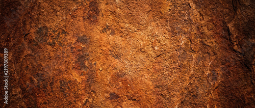 Close-up of weathered sandstone surface, natural earthy texture background.