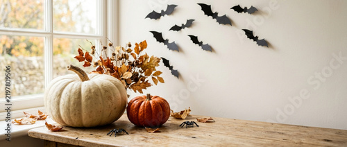 Autumn Halloween Decorations: Pumpkins, Bats, and Spiders by Window