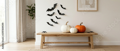 Cozy Halloween Decor: Pumpkins, Bats and Spiders on Wooden Bench