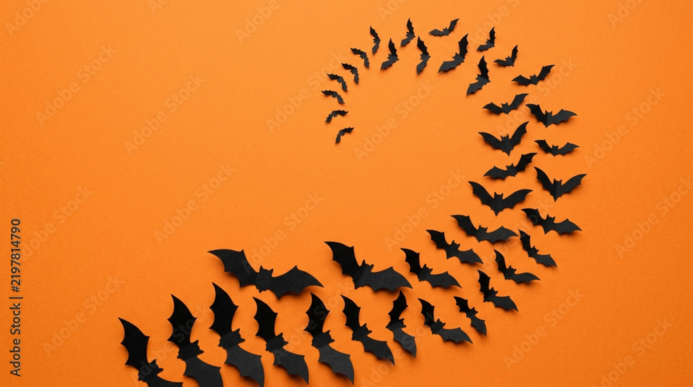 Obraz premium Halloween bats spiral on orange background, spooky festive decoration