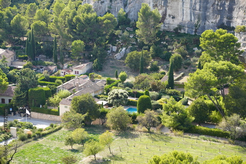 Obraz na plátně Pine and broadleaf trees surround a hillside European style house with pool