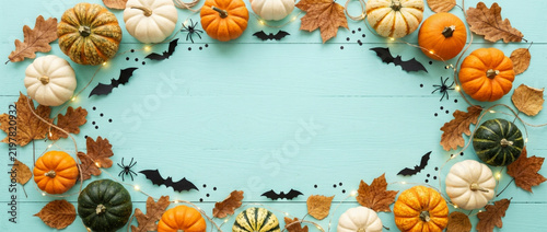Halloween festive frame with pumpkins, bats, spiders, leaves, and fairy lights