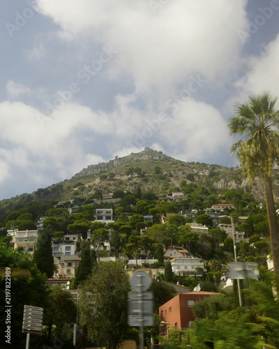 Fotografie Rocky, green hillside dotted with villas and houses