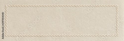 Textured beige paper background with braided rope border