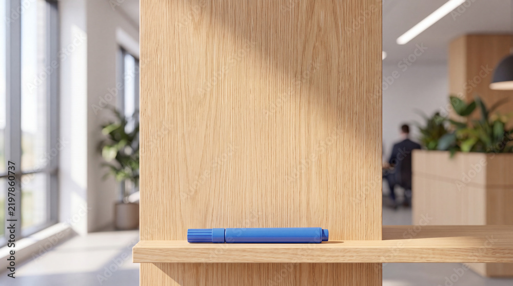Fototapeta premium Blue whiteboard marker lying on a wooden shelf against a wooden wall partition in a modern bright office interior workspace with blurred background people and plants for mockup