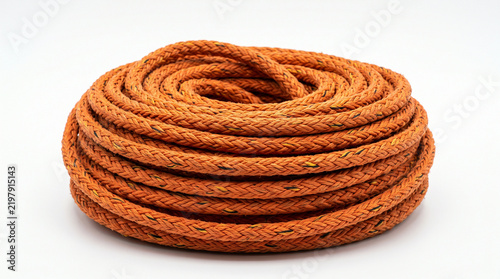 Coiled orange industrial safety rope isolated on a clean white background