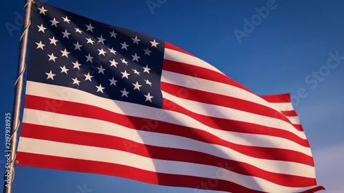 American flag waving in the wind against a clear blue sky, patriotic motion