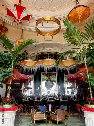 Elegant Bar Parasol Lounge Interior With Tropical Plants, Chandeliers and Vintage Seating