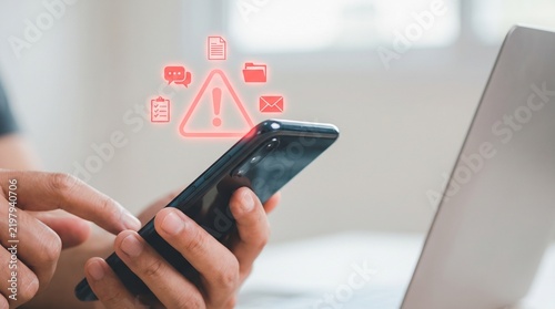 Close up view of hands holding smartphone with red cyber security alert icons for data protection warnings alert notification warning sign digital threat mobile security data breach hacker attac