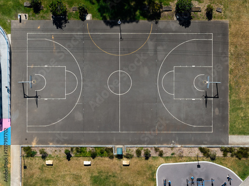 Top down view of basketball court with black surface.