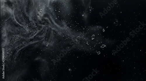 Black smoke with floating white dust particles and glowing light sparks in dark atmosphere