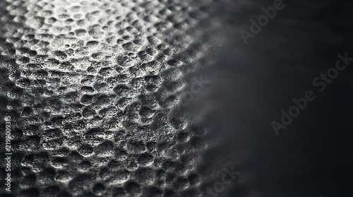 Sunlight reflecting on the dark rippling surface of water in the evening