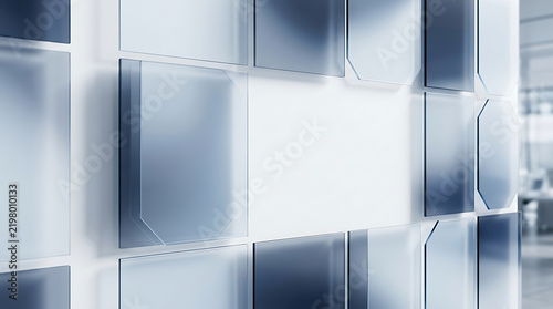 Abstract wall with silver metal panels and glowing light in a modern office building interior
