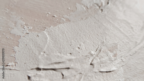 A heavy dynamic layer of white acrylic paint creating dimensional waves on a studio canvas. thick medium, modern art, creative workspace, expressionist background.