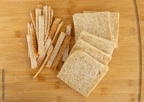 фотографія Cutting the crusts off, crustless bread for sandwiches closeup