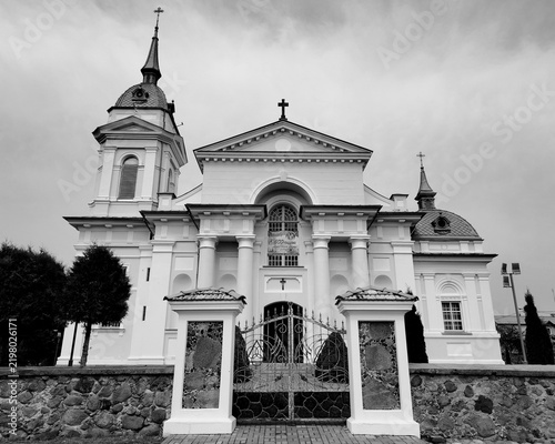 Bild auf Leinwand Monochrome symmetric facade of a classical Catholic church with columns and ston