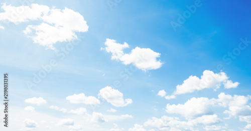 the sky is full of white clouds, bright blue, and beautiful sunlight.