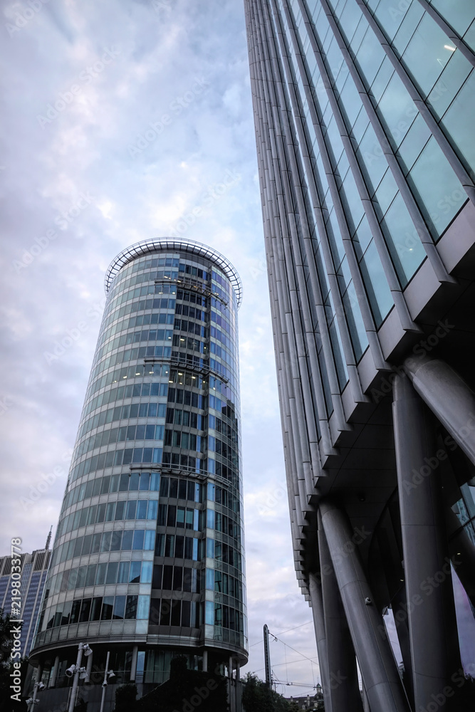 Obraz premium Brussels North, Belgium Low angle view of modern high rise glass corporate office skyscrapers architecture under cloudy sky