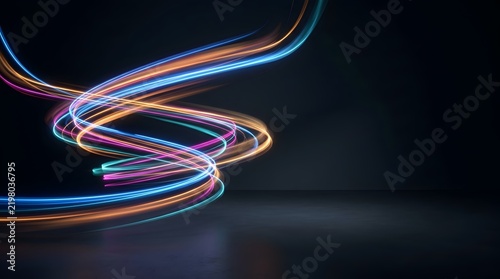Abstract glowing light trails in blue and orange against dark background