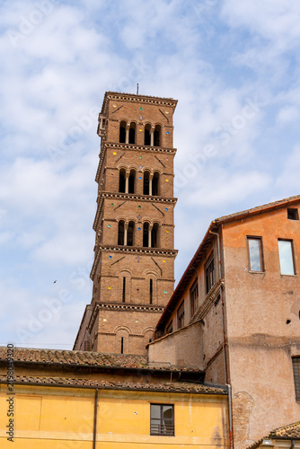 Quadro su tela Ancient Roman bell tower with arched windows and colorful mosaic details against