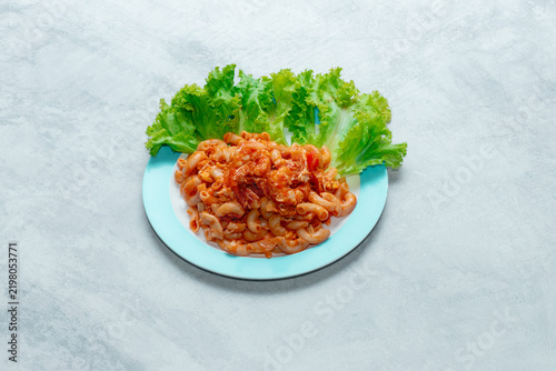 Принти на полотні Macaroni pasta stir-fried with egg, onions, tomatoes, and your choice of meat in a sweet and savory tomato sauce