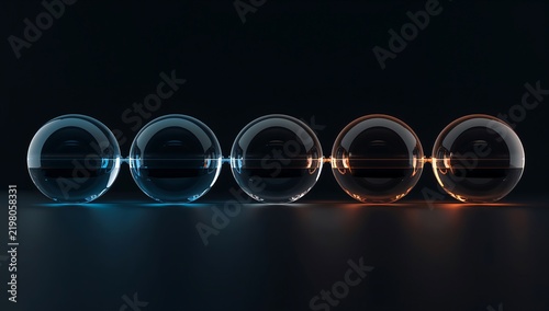 Five glowing glass spheres connected in a row on dark background