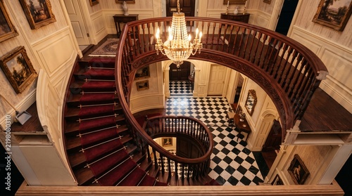Grand Georgian dollhouse interior showcasing elegant mahogany staircase and ornate panelled hallway