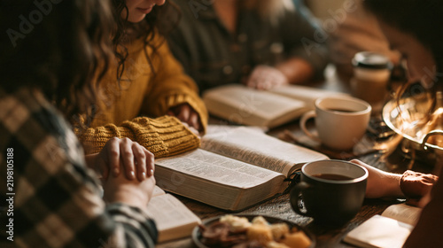 A group of women gather around a wooden table in warm light, reading an open Bible together. This heartfelt scene is perfect for Christian fellowship and devotion concepts.